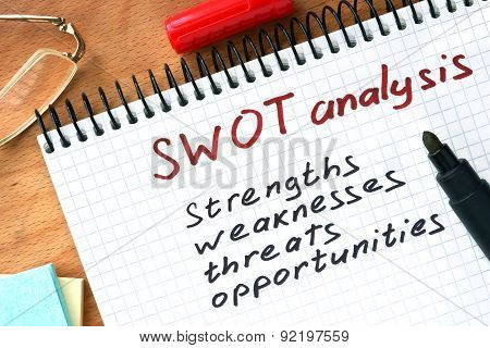 Notepad with  SWOT analysis concept