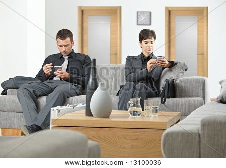Business mennesker siddende på sofaen på office forværelse venter.