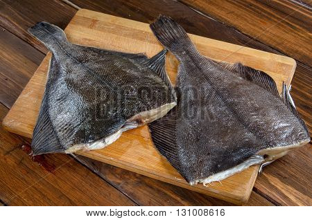 Raw fish flounder, flatfish on wooden table