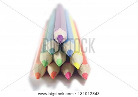 set of colored pencils on white drawing paper