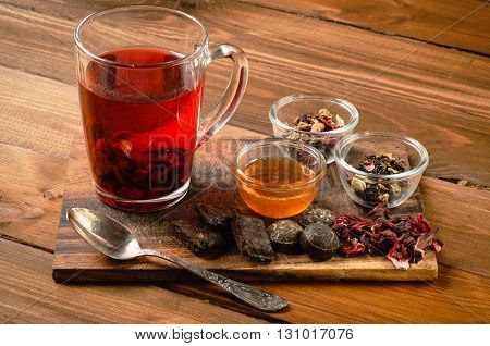 Tea composition with old spoon on wooden table