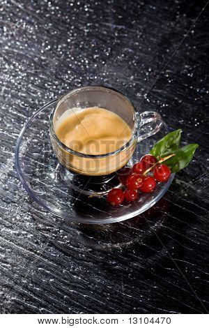 Cofee espresso con ribes sul tavolo di vetro nero