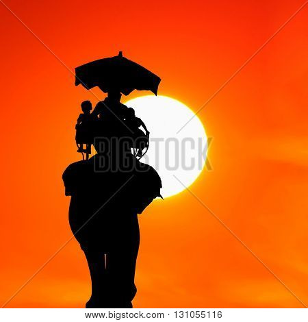 silhouette elephant with tourist at beautiful sunset