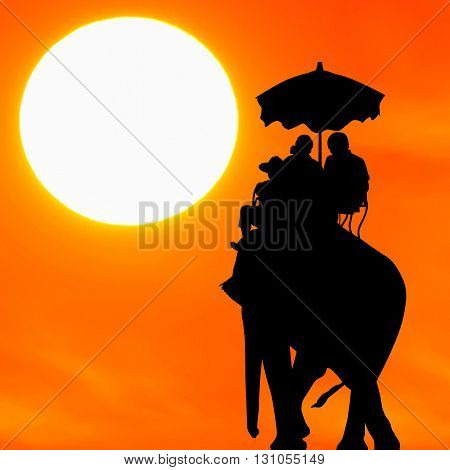 silhouette elephant with tourist at beautiful sunset