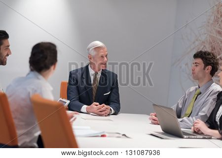 business people group brainstorming on meeting and businessman presenting ideas and projects oon laptop and tablet computer
