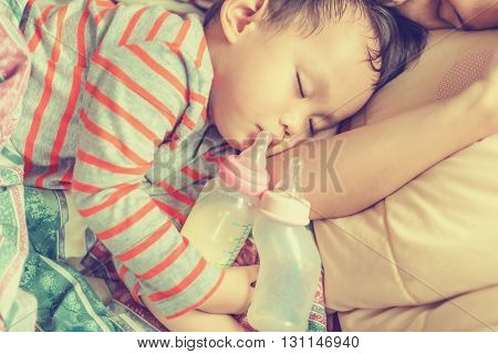 Asian Baby Boy Sleeping In Mother Arm