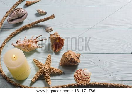 Concept of the summer time with fish star and sea shells on the wooden blue background, flat lay. Summer time sea vacation.