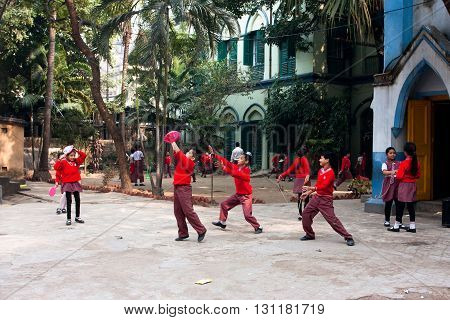 KOLKATA, INDIA - JAN 17, 2013: Unidentified school children play frisbee outdoor on January 17, 2013 in Kolkata West Bengal India. West Bengal state has 18 universities and 136 affiliated colleges