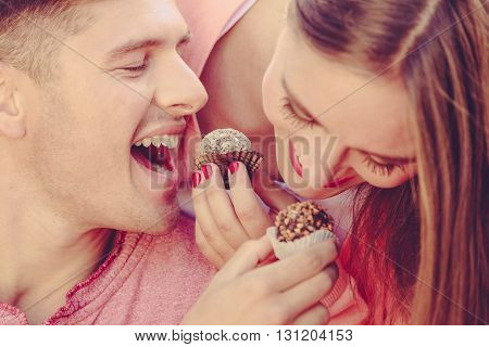 Smiling Couple Feeding Each Other.