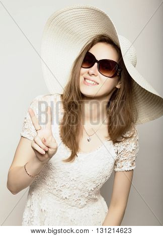 beautiful girl in broad-brimmed hat and sunglasses posing and expresses different emotions.