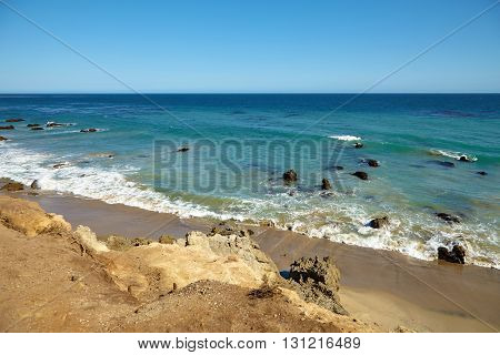 Waves beating against coastal rocks on the cliffs in Malibu California