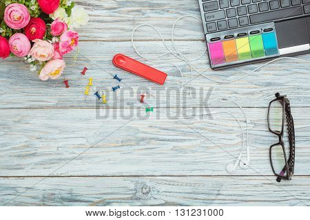 Workplace: laptop on table and glasses flat lay