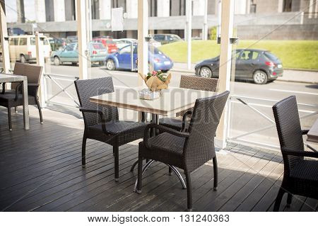 Open terrace with wooden tables in the city