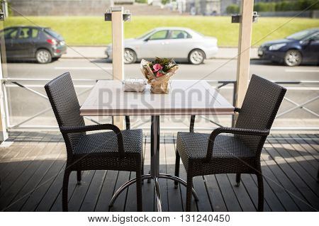 Open terrace with wooden tables in the city