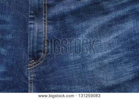 fragment closeup of trousers from jeans material or jeans clothes with a codpiece for the textile textured background of blue color