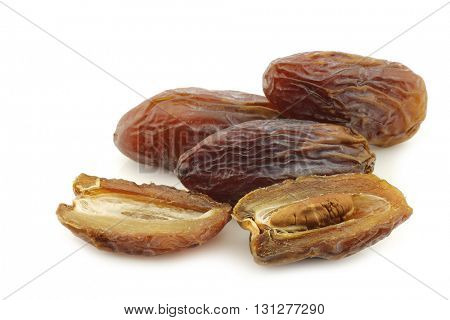 date fruit and an opened one on a white background