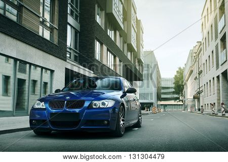 Moscow, Russia - May 10, 2015: Blue car BMW 5 series E90/E91 stay on asphalt road in the city Moscow at daytime