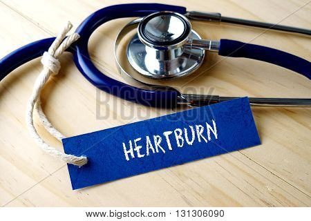 Medical Conceptual Image With Heartburn Word Written On Label Tag And Stethoscope On Wooden Backgrou