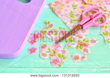 Decorative painted chopping board. Cut pieces of napkins. Scissors, flowers napkin fragments. Decoupage tutorial - decorating kitchen cutting board.