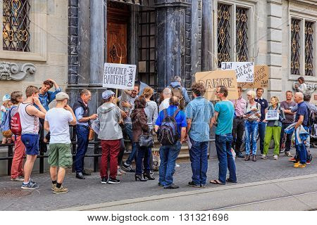 Zurich, Switzerland - 25 May, 2016: people with banners at the entrance to the Zurich Town Hall building. Zurich Town Hall (German: Zurich Rathaus) houses the cantonal parliament (German: Kantonsrat) and the city parliament (German: Gemeinderat).