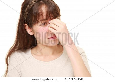 studio shot of young woman suffers from Asthenopia
