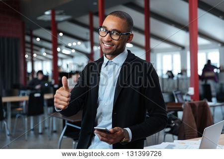Smilling young businessman show okay sign in the office