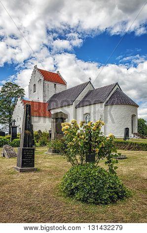 An image of the old white Ravlunda church in the swedish region of Skane.