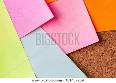 business, information, memo, management and education concept - close up of blank paper stickers on cork board