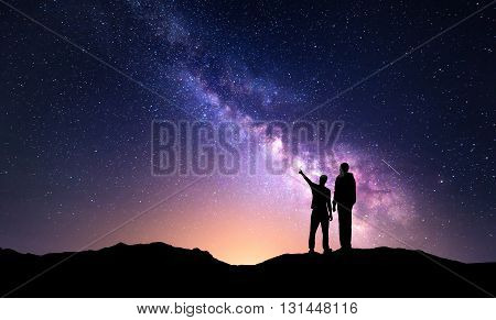 Landscape With Milky Way. Silhouette Of A Father And Son