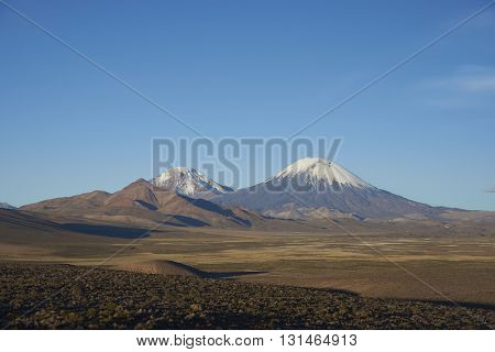 Snow and ice covered peak of the volcano Parinacota (6342m) on the altiplano in Lauca National Park, northern Chile.