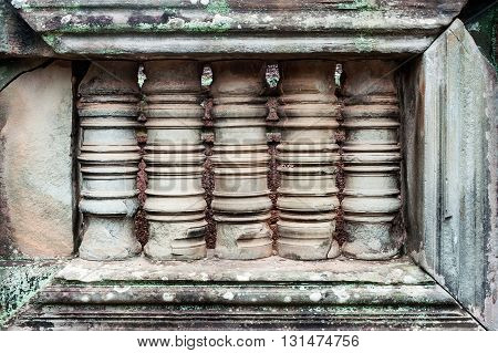 Stone carved window with columns Angkor complex Siem Reap Cambodia