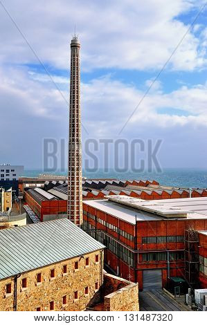 old port warehouses Savona with chimney and blue sky