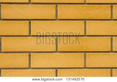 New flat brick wall of beige color with deep seams.