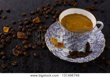 Coffee grains and china cup of coffee. Coffee cup. Strong coffee. Coffee mug. Morning coffee. Cup of coffee. Coffee break.