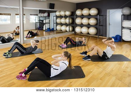 High Angle View Of Friends Doing Situps