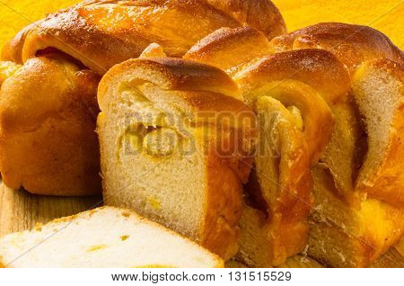 peach strudel to a wooden Board on a bright yellow textile background