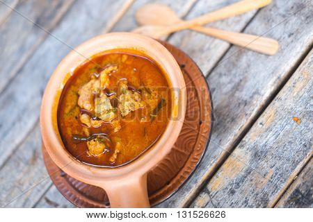 Thai panang pork curry on wood table