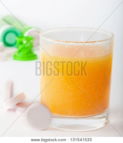 Effervescent vitamin and calcium tablets juice with bubbles