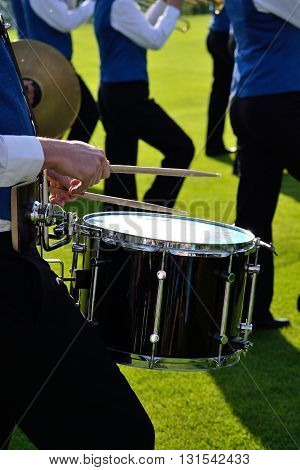 Musicians in costume playing drum - close-up