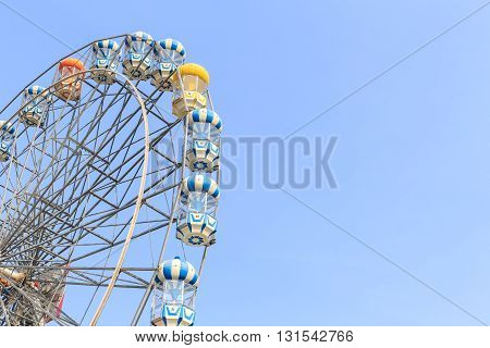 Brightly Colored Ferris Wheel On The Blue Sky