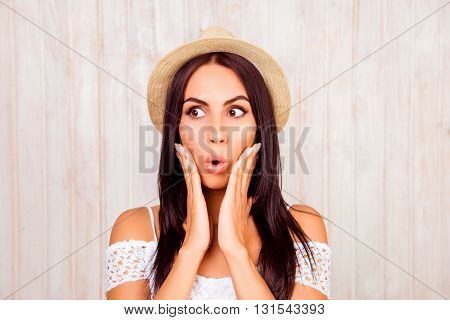 Portrait Of Shocked Woman In Summer Hat Touching Her Face