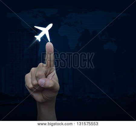 Hand pressing airplane icon over map and city tower Airplane transportation concept Elements of this image furnished by NASA