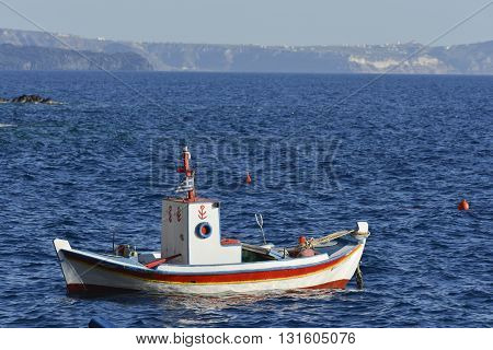 fisherman boat in Greek water at Amoudi Santorini