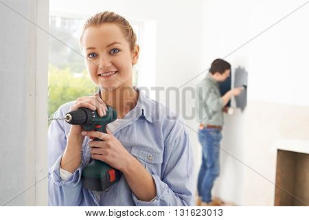 Portrait Of Young Couple Rennovating Property Together