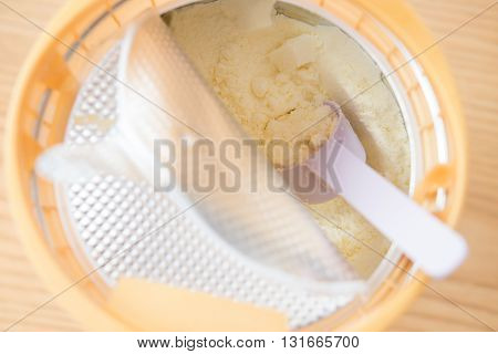 can of powdered milk for children on wooden table close up