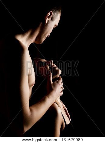 Close-Up Beautiful sexy young couple, naked man and woman on black background.