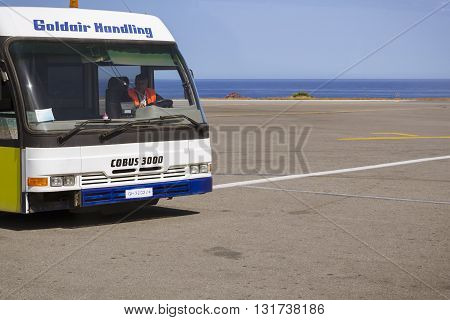HERAKLION GREECE - APRIL 28 2016: Aviation services airport bus Cobus 3000 with driver in the cab at Heraklion Airport N. Kazantzakis. Crete Greece