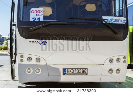 HERAKLION GREECE - APRIL 28 2016: Modern white tourist bus with logo of Anex Tour company and DeltaNet transport parked at Heraklion Airport N. Kazantzakis Crete Greece