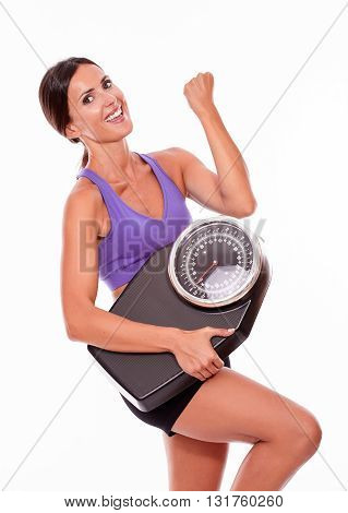 Healthy Smiling Brunette With A Scale