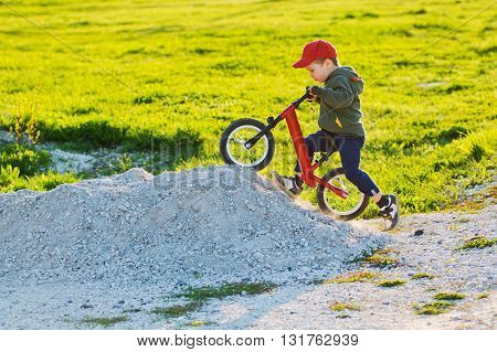 child on bike balance is drawn up on the mountain
